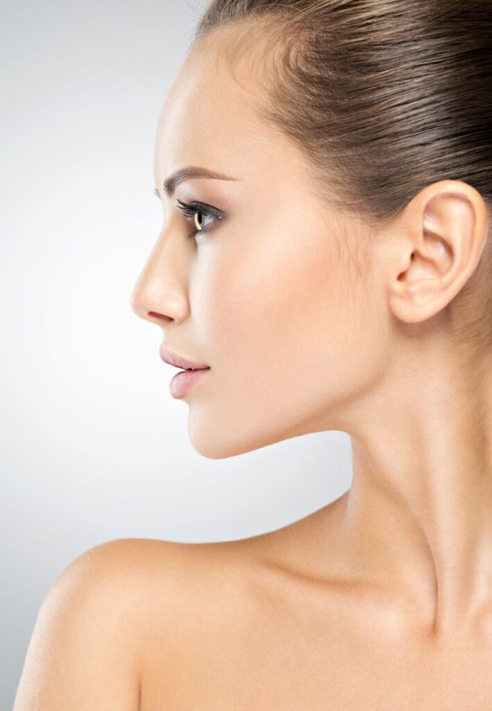 Side profile closeup of a woman with smooth, youthful skin after quantum treatment